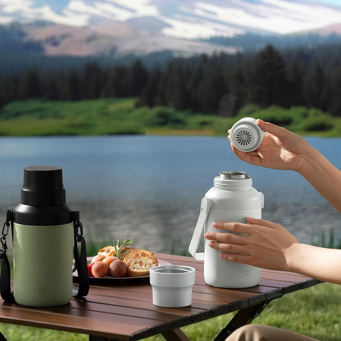Thermos drinking lid and strainer outdoors; additional green thermos not included