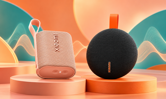 Xiaomi Sound Pocket in pink and Xiaomi Bluetooth Speaker Essential in black on an orange and teal comparison cover