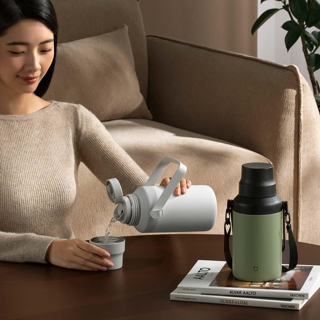 White Mijia thermos being poured into its cup lid