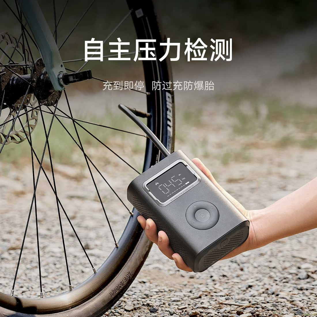 Mijia Air Compressor 2 Pro inflating a bicycle tyre, complete unit held in hand