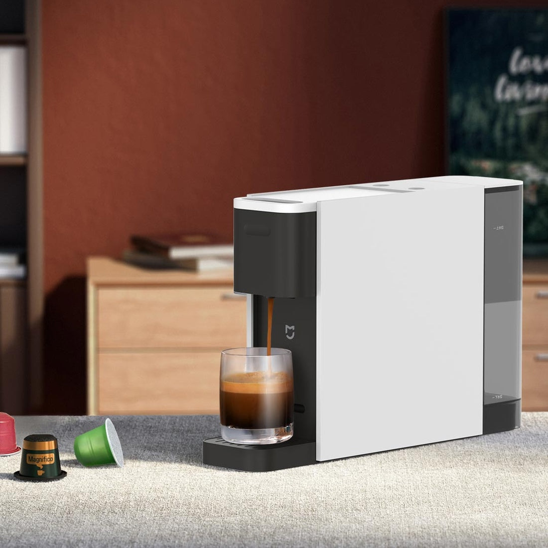 Xiaomi Mijia N1 capsule coffee machine dispensing espresso; cup and capsules are serving props