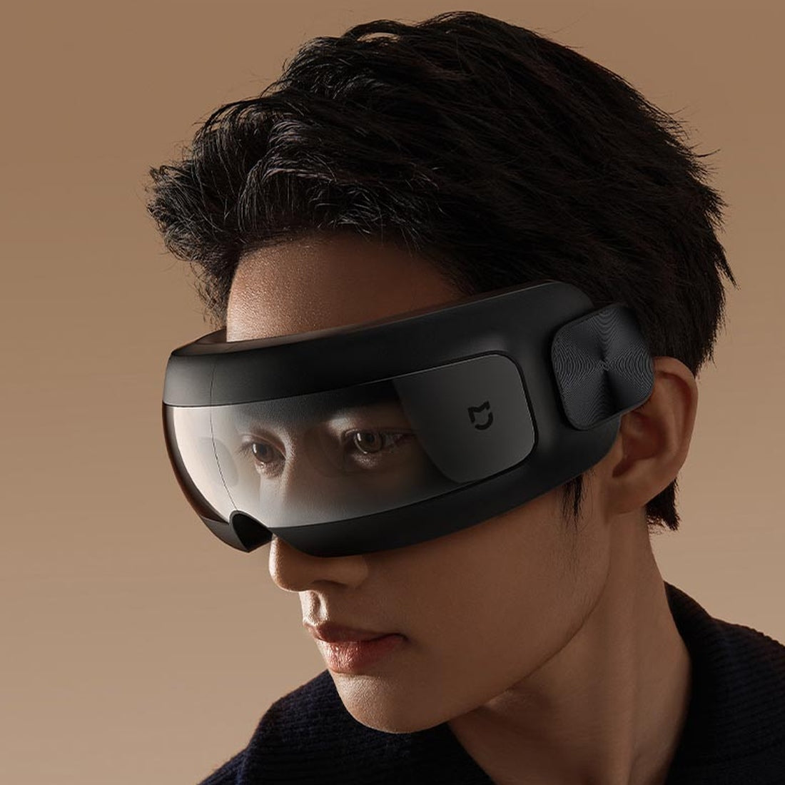 Xiaomi Mijia Smart Eye Massager worn while resting; manufacturer see-through design illustration