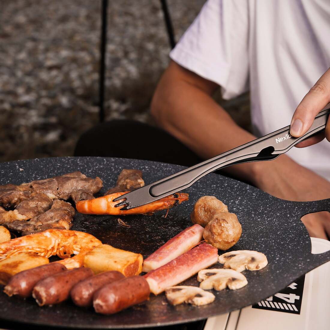 NexTool detachable barbecue tongs used at the grill