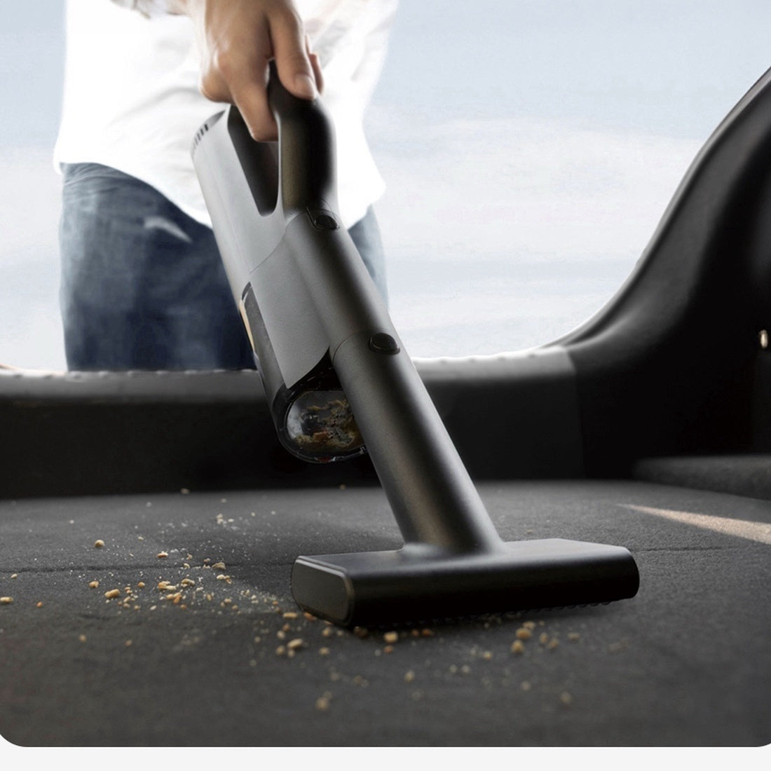 Mijia cordless car vacuum cleaning a vehicle floor mat with the wide nozzle