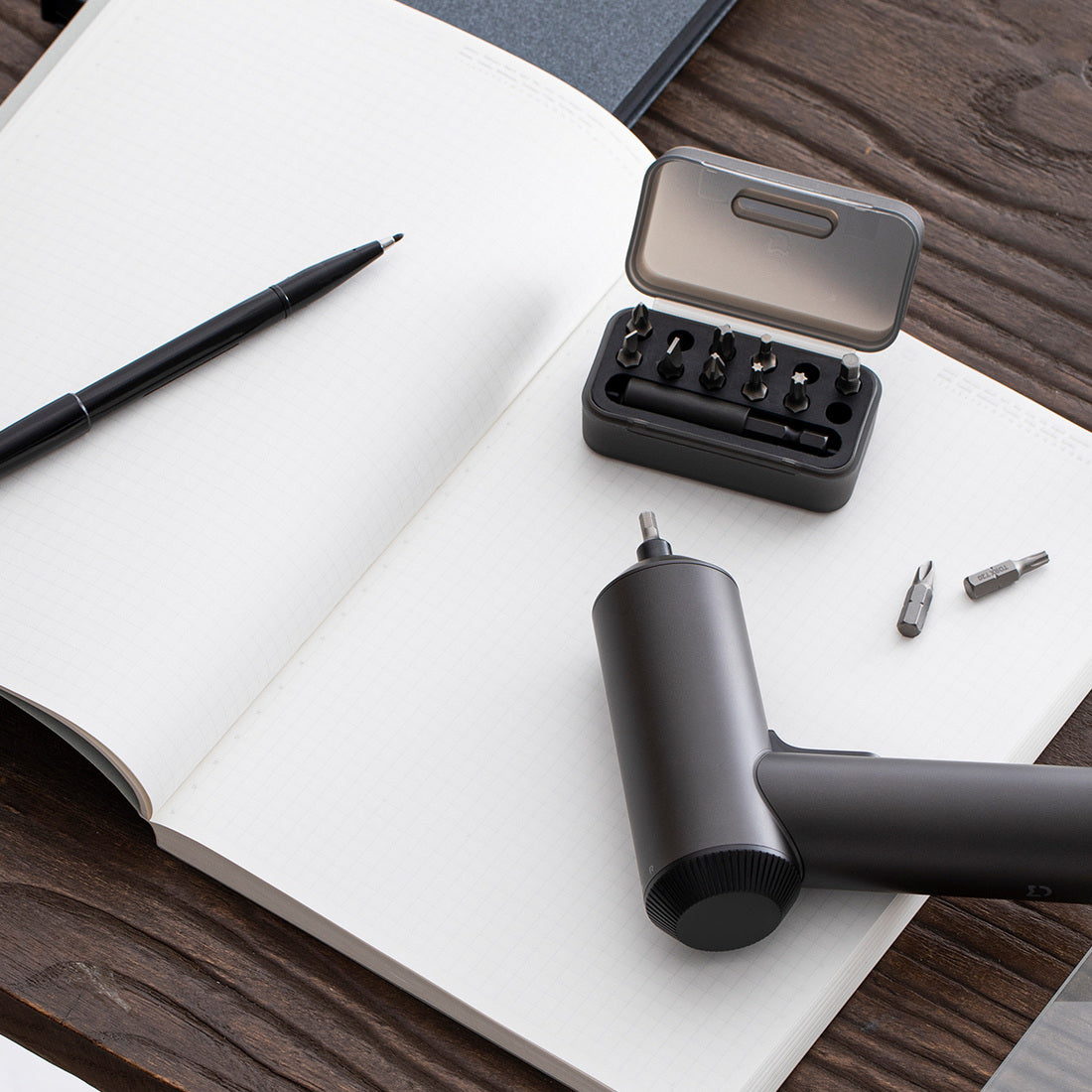 Mijia screwdriver on desk with supplied bit storage case