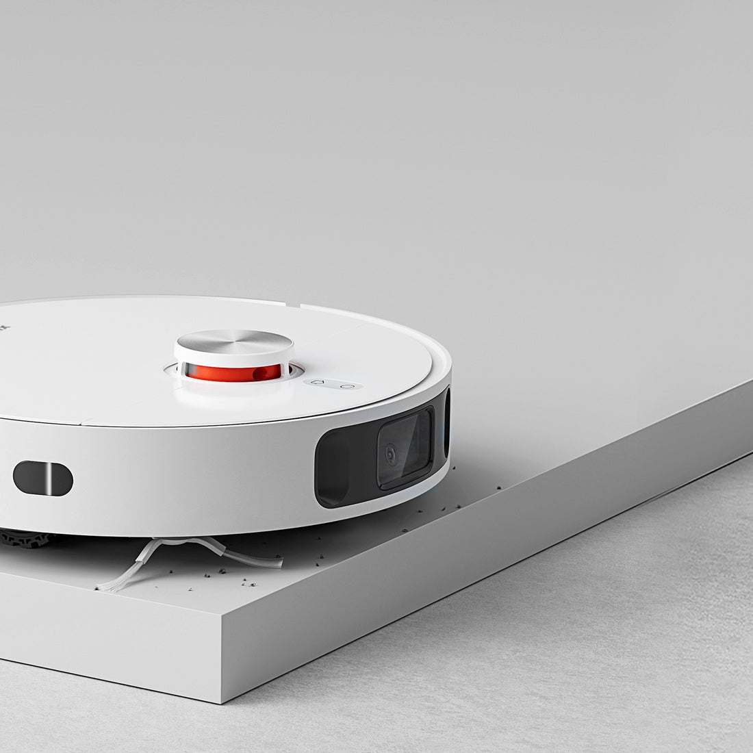 Compatible Xiaomi robot sweeping close to an edge; vacuum not included