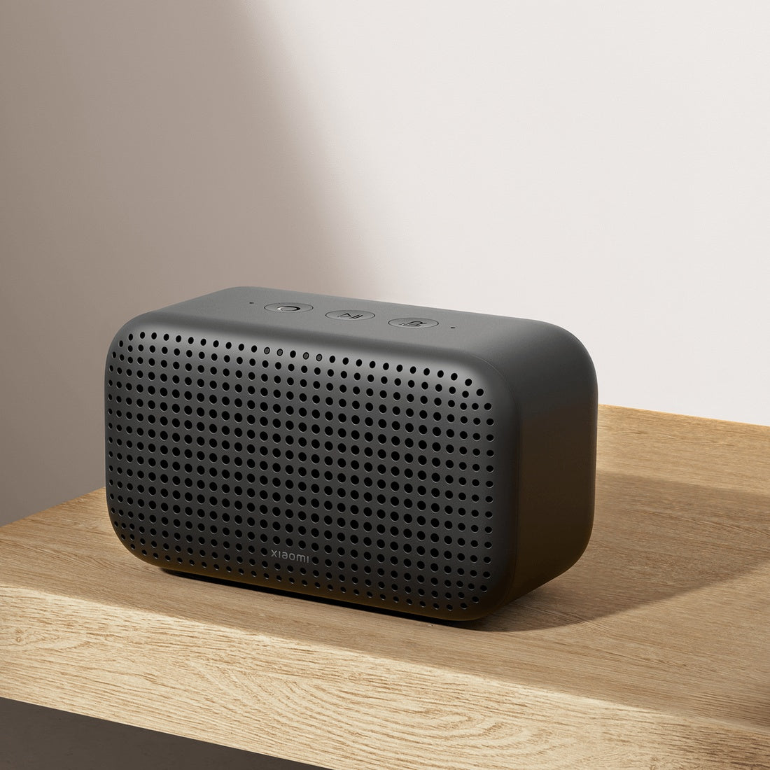 Xiaomi Smart Speaker Lite black on a wooden shelf